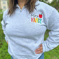 Personalized Teacher Name Quarter Zip Sweater Shown in Ash Color - Teachers name is Embroidered in Rainbow with an apple - On Model