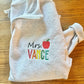 Personalized Teacher Name Quarter Zip Sweater Shown in Ash Color - Teachers name is Embroidered in Rainbow with an apple - Flatlay