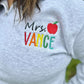 Personalized Teacher Name Quarter Zip Sweater Shown in Ash Color - Teachers name is Embroidered in Rainbow with an apple - On Model