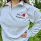 Embroidered Teacher name with Apple on Quarter Zip Sweater shown in the Color Ash - On Model