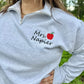 Embroidered Teacher name with Apple on Quarter Zip Sweater shown in the Color Ash - On Model